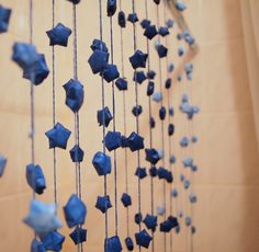 blue glass beads hanging from the ceiling in a room