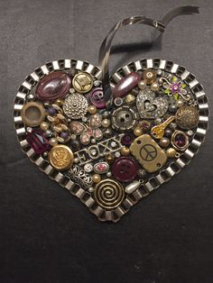 a heart shaped brooch sitting on top of a table