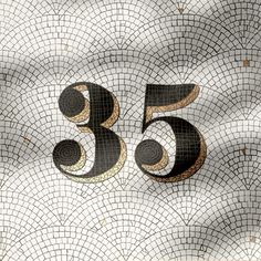 the number 55 is made up of black and gold circles on a mosaic tile background