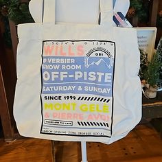 a white tote bag with an advertisement on the front and back of it that says, mill's everbier snow room off - piste saturday & sunday