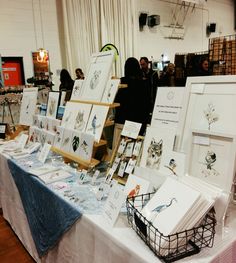 a table covered with lots of art and pictures