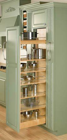 an open cabinet in the middle of a kitchen with pots and pans on it