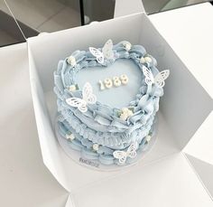 a heart shaped cake in a box with butterflies on it and the number 891