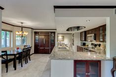 a large kitchen and dining room with marble counter tops