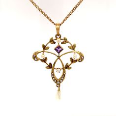 True Romance is an amazing, one-of-a-kind, turn of the 20th century, vintage necklace, featuring a delicate circular and trefoil pendant adorned with one old mine cut diamond, a square cut amethyst, and 17 seed pearls. This is truly a work of art and is stunning. The 10K yellow gold necklace is 18.5" with a spring ring closure. The total approximate weight including all materials is 3.10 dwt. Center Diamond: Old Mine Cut; Color Grade: F-G; Clarity Grade: SI1-SI2; Dimensions: 2.20mm; Total Carat Heirloom Necklace Vintage, Antique Wedding Necklaces With Jewels, Antique Yellow Gold Necklaces With Jewels, Antique Gemstone Necklace For Wedding, Heirloom Necklace With Rose Cut Diamonds As A Gift, Heirloom Style Necklaces With Rose Cut Diamonds For Gift, Antique Yellow Gold Jeweled Necklaces, Heirloom Necklace With Rose Cut Diamonds For Gifts, Antique Pearl Necklace For Formal Occasions