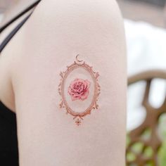 a woman with a pink rose tattoo on her arm