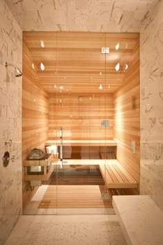 a bathroom with a sauna in the middle and lights on all over it's walls