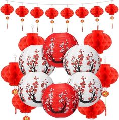 red and white paper lanterns with cherry blossom designs hanging from the ceiling, surrounded by decorations