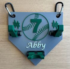 a baseball themed birthday card with the number seven on it and two hooks attached to it