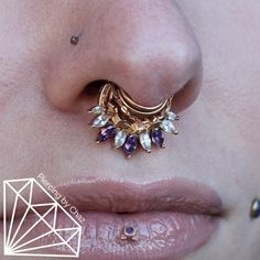 a close up of a woman's nose with an earring on top of it