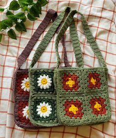 two crocheted purses sitting on top of a bed