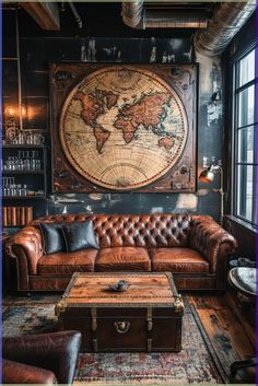 a living room with leather couches and a large map on the wall above it