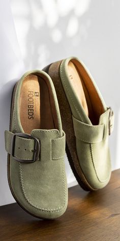 The Bueno by White Mountain Shoes is a moccasin-style clog that is comfortable and cute! This leather clog has a contoured footbed to hug your foot and a soft cork bottom for maximum comfort. The oversized statement buckle makes this clog stand out. Green Casual Mules With Leather Footbed, Leather Slip-on Slippers With Buckle Closure, Comfortable Flat Heel Mules With Buckle Closure, Comfortable Leather Footbed Clogs For Fall, Casual Green Leather Clogs, Casual Fall Mules With Buckle Closure, Comfortable Clogs With Buckle Closure And Flat Heel, Leather Clogs With Buckle Closure For Fall, Green Leather Footbed Clogs With Round Toe