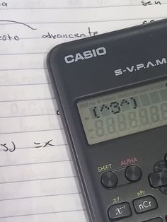 a calculator sitting on top of a piece of paper