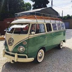 an old vw bus with a surfboard on the roof