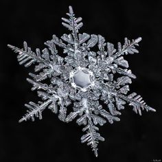 a snowflake is shown on a black background