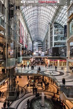 the inside of a shopping mall with people walking around