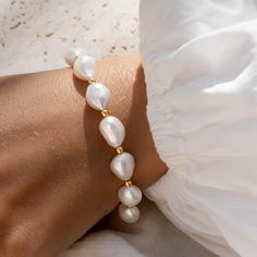 Our Pearl Bracelet (Ingrid) features baroque pearls studded with gold nuggets. This statement bracelet has adjustable length settings and can be worn at lengths between 6.5" and 8".

Baroque pearls measure at ~9.5 - 10mm. Beading Jewelery, Gold Nugget, Freshwater Pearl Bracelet, Handmade Jewelry Diy, Large Hoop Earrings, Sustainable Jewelry, Freshwater Cultured Pearls, Statement Bracelet, Traditional Jewelry