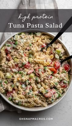 a bowl filled with tuna pasta salad on top of a table