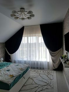 a bed room with a neatly made bed next to a window covered in curtains and drapes