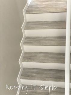 a white stair case with wood slats