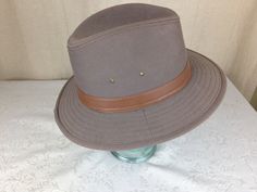 A very nice all weather and shapeable hat by Dorfman Pacific. It is called the Glendale style and has a pinchfront crown with a 2 7/8 inch brim. It is a soft cloth twill cotton material with a soft wire in the brim for easy shaping. This is a very clean hat with no noted flaws or issues. the size is listed as a large, but will comfortably fit a 7 1/8 to 7 1/4. Classic Solid Bucket Hat For Outdoor, Classic Solid Color Bucket Hat For Outdoor, Classic Brown Bucket Hat With Flat Brim, Classic Adjustable Top Hat For Outdoor, Brown Brimmed Cloche Hat For Outdoor, Classic Brown Bucket Hat With Short Brim, Classic Hunting Hat With Short Brim, Western Style Adjustable Flat Cap, Adjustable Western Style Flat Cap