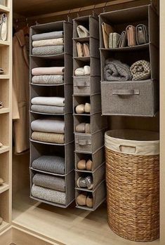 the closet is organized with baskets and linens