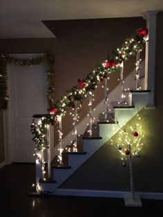 stairs decorated with christmas lights and garland