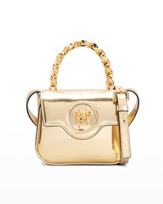 Versace crossbody bag in metallic leather with golden metal finish hardware  Structured chain top handle  Removable, adjustable shoulder strap, 19.7" drop Flap top with magnetic closure; Medusa head accent  Interior, three card slots  Approx. 4.7"H x 6.3"W x 2.4"D Made in Italy Versace La Medusa Bag, Chain Top, Versace Bags, Best Black Friday, Chain Crossbody Bag, Gianni Versace, Leather Items, Handle Bag, Metallic Leather