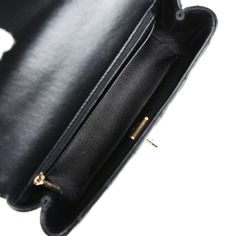 This Mini Rectangular flap bag is in black lambskin with light gold tone hardware and has a front flap with signature CC turnlock closure, rear half moon pocket, a faux crystal and black leather top handle and single interwoven black leather and light gold tone chain link shoulder/crossbody strap.The interior is lined in black leather and features a zipper pocket with Chanel pull and an open pocket below.Collection: 23A (RFID Chip)Origin: ItalyCondition: New and never worn (plastic on hardware)Accompanied by: Chanel box, Chanel dustbag, carebook, felt, RFID, retail UPC and ribbonMeasurements: 8" width x 5" height x 3" depth; 1.5" top handle, 20" strap drop Luxury Evening Flap Bag With Cc Turnlock Closure, Formal Double Flap Shoulder Bag With Cc Turnlock Closure, Timeless Evening Flap Bag With Cc Turnlock Closure, Evening Flap Bag With Cc Turnlock And Top Handle, Classic Business Flap Bag With Cc Turnlock Closure, Luxury Flap Bag With Cc Turnlock Closure For Travel, Timeless Rectangular Flap Bag With Cc Turnlock, Leather Flap Bag With Cc Turnlock For Evening, Luxury Double Flap Bag With Cc Turnlock Closure