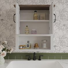 a white sink sitting under a bathroom mirror next to a wall mounted faucet