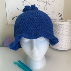 a crocheted hat sits on top of a mannequin head