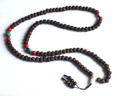 This is a Indian Bodhi Seed Mala with dark brown color Side cut.Its has been decorate with Naga shell and Red coral Beads. Handmade in Nepal. 11mm 108 beads 24inch long Necklace. Meditation Buddha Shop For Nepali handmade Products. We Supports Small Family Artisans who create a Beautiful handmade rituals Products. Brown Wooden Beads Spiritual Mala, Spiritual Brown Wooden Beads Mala, Brown Polished Beads Mala For Meditation, Traditional Brown Beads For Meditation, Handmade Brown Beads For Puja, Brown 8mm Beads Mala For Festival, Brown Mala With 8mm Beads For Festival, Traditional Brown Mala With 8mm Beads, Brown Beaded Spiritual Mala