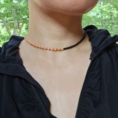 Choker necklace made with beautiful orange, matte black, gold, gilt lined white opal Miyuki beads. 14K gold plated 316 stainless steel lobster claw clasp. This Necklace also come in light blue. Safe to wear in water.  All Jewelry pieces in this store are designed and handmade by myself.  Please message me if you want a different length. Adjustable Orange Beaded Necklace With Faceted Beads, Orange Tiny Beads Choker Necklace, Orange Beaded Choker With Tiny Beads, Handmade Orange Beaded Choker Necklace, Orange Beaded Necklaces With Spacer Beads As Gift, Adjustable Orange Necklace With Spacer Beads, Orange Necklace With Black Beads For Gift, Orange Necklace With Black Round Beads, Adjustable Orange Beaded Necklace