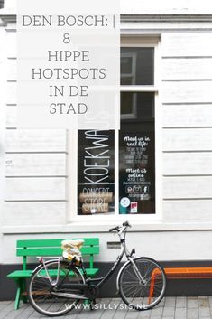 a bike parked next to a green bench in front of a white building with the words den bosche 8 hippe hotspots in de stad