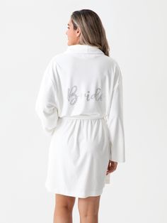 Get ready for your big day in true bridal style with Shiraleah's “Bride” Robe. This luxuriously soft robe features two front pockets and an adjustable wrap around belt, allowing you to be cozy and casual through hours of hair and makeup. Chic and feminine silver rhinestones spell the word “Bride” across the back, helping you to celebrate your wedding day from the moment you step out of the shower. Pair with other items from Shiraleah's Hitched collection to complete your look! Shiraleah is a tre Gifts For The Bride, Spa Wraps, Soft Robes, Scarf Hat, Silver Rhinestone, Hair And Makeup, Perfect Gift For Her, Summer Hats, Scarf Hairstyles