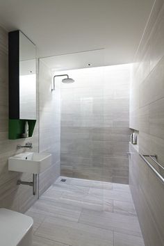 an image of a bathroom with white tile on the walls