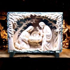 the nativity scene is made out of white marble and features an image of three wise men