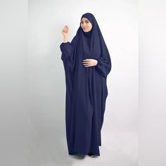 One Piece Khimar Abaya Dress Color: Navy Blue (To Buy Other Colors, Please See Separate Listings) One-Piece Ensemble: Seamlessly Combines Khimar And Abaya For A Complete, Modest Look. Tie-Back Feature For Flexible Adjustment Of Khimar. Chin Piece Can Also Be Brought To Use It As A Niqab Using Hijab Magnets Or Pins Elastic Balloon Sleeves: Ensures Comfort And Flexibility During Prayers. Length: 176cm From Head To Bottom, Gracefully Drapes For A Modest And Elegant Appearance And Is Loose Silhouett Blue Long Khimar For Eid, Long Blue Khimar For Eid, Blue Long Sleeve Modest Khimar, Modest Long Sleeve Blue Kaftan, Blue Modest Long Abaya, Modest Blue Maxi Length Abaya, Modest Blue Dresses For Eid, Casual Long Blue Abaya, Modest Long Blue Dresses