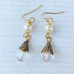 "Beautiful faceted crystal ab teardrop cupped in a filigree bead cap suspended from a pearl make these earrings a classic bridal style or perfect night out earring. 1 3/4\" total length great gift or treat yourself. Thanks for looking!" Pearl Teardrop Crystal Earrings For Party, Party Pearl Teardrop Crystal Earrings, Party Teardrop Pearl Crystal Earrings, Gold Crystal Earrings With Pearl Charm, Elegant Beaded Teardrop Drop Earrings, Pearl Drop Dangle Crystal Earrings, Elegant Beaded Cream Earrings, Elegant Beaded Teardrop Crystal Earrings, Pearl White Drop Earrings With Pearl Drop Detail