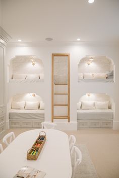 a room with white furniture and bunk beds