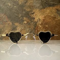 These heart sunglasses are wrapped with black and gold wire.Comes with a cleaning cloth and a pouch to store the sunglasses in. All orders include freebie crystals and stickers. Trendy Black Heart-shaped Sunglasses, Black Sunglasses With Tinted Lenses As Gift, Black Sunglasses With Tinted Lenses For Gift, Chic Sunglasses With Tinted Lenses, Black Sunglasses With Tinted Lenses, Black Tinted Sunglasses As A Gift, Adjustable Sunglasses With Gradient Lenses As Gift, Heart-shaped Glass Sunglasses For Gift, Heart-shaped Glass Sunglasses As Gift