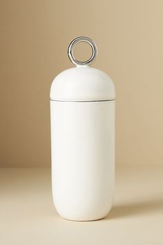 a white canister sitting on top of a table