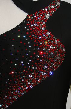 a black dress with red and silver sequins