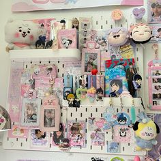 there are many items on the shelf in this room that is filled with dolls and other things