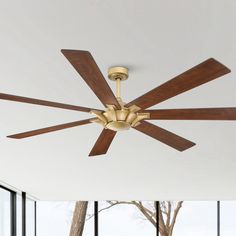 a ceiling fan with wooden blades in a living room