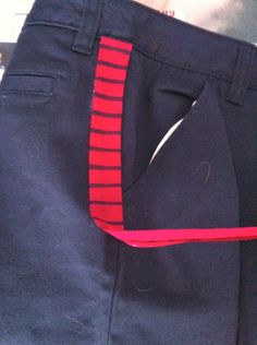 there is a pair of pants with red and black stripes on the bottom half of it