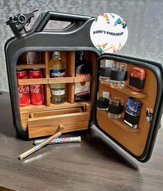 an open case with spices and condiments in it on a wooden table next to a wall