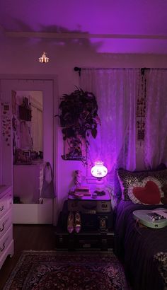 a bedroom with purple lighting in the corner and a bed on top of a rug