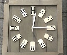 a clock made out of dominos on the wall